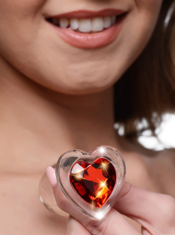 Decorate your derriere with a sparkling red heart! Display your love between your cheeks with these see-through glass butt plugs - the solid mass and smooth surface fills your backdoor with a satisfyingly hard sensation! Perfect for warming up or as a dedicated anal pleasure toy.   Smooth and tapered for easy entry without discomfort and compatible with most lubricants so you can play your way. Heat or chill this heart shaped anal dream for an an extra layer of pleasure!  This see through glass plug is naturally body safe and hypoallergenic for those with sensitive bodies. The smooth texture also makes these plugs easy to clean with warm water and mild soap - be sure to clean before and after use!  Perfect for warming up your backdoor for rougher play or simply as a treat for the eyes for your partner while they enjoy the rest of your body! This medium sized plug is perfect for intermediate anal players or for beginners seeking to stretch their hole to the next level. Insert this heart shaped Booty Spark and make that booty sparkle! Measurements: Overall length 2.8 inches